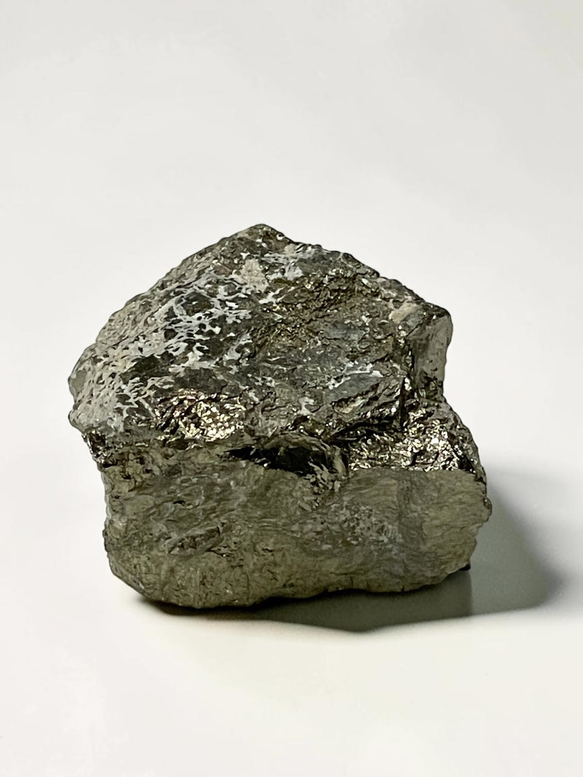 Side view of Climax Mine pyrite specimen showing blocky form and varied surface texture