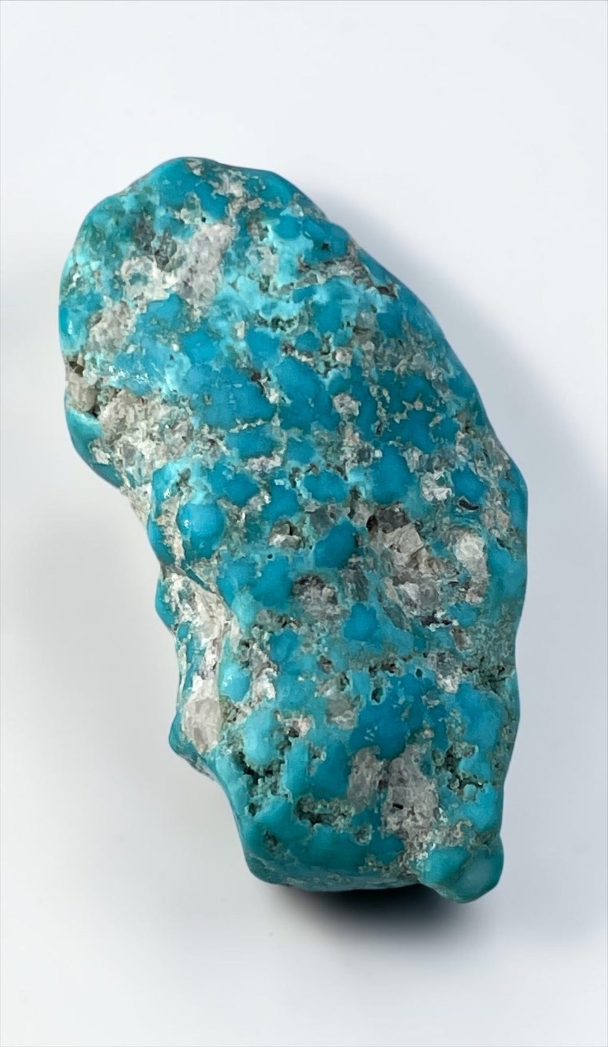 Front view of vivid blue hand-polished Leadville turquoise specimen with quartz-rich matrix